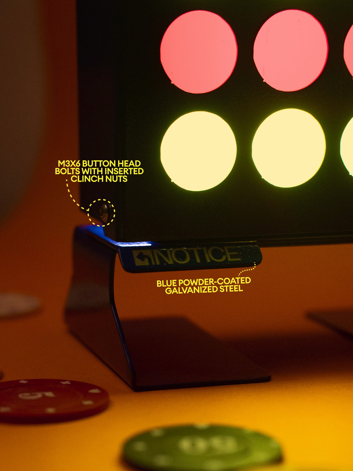 Close-up of the Stack 4 Lamp base with M3 button-head bolts and the NOTICE pull tab