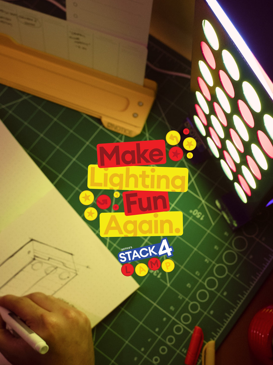 Make lighting fun again. Stack 4 Lamp glowing beside a sketch on a cutting mat
